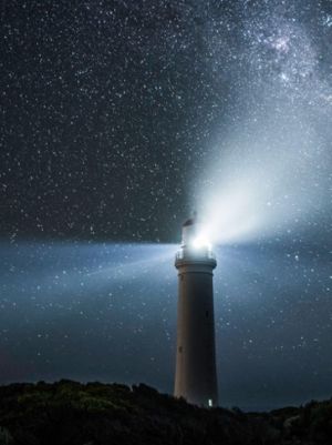 lighthouse beacon on starry night